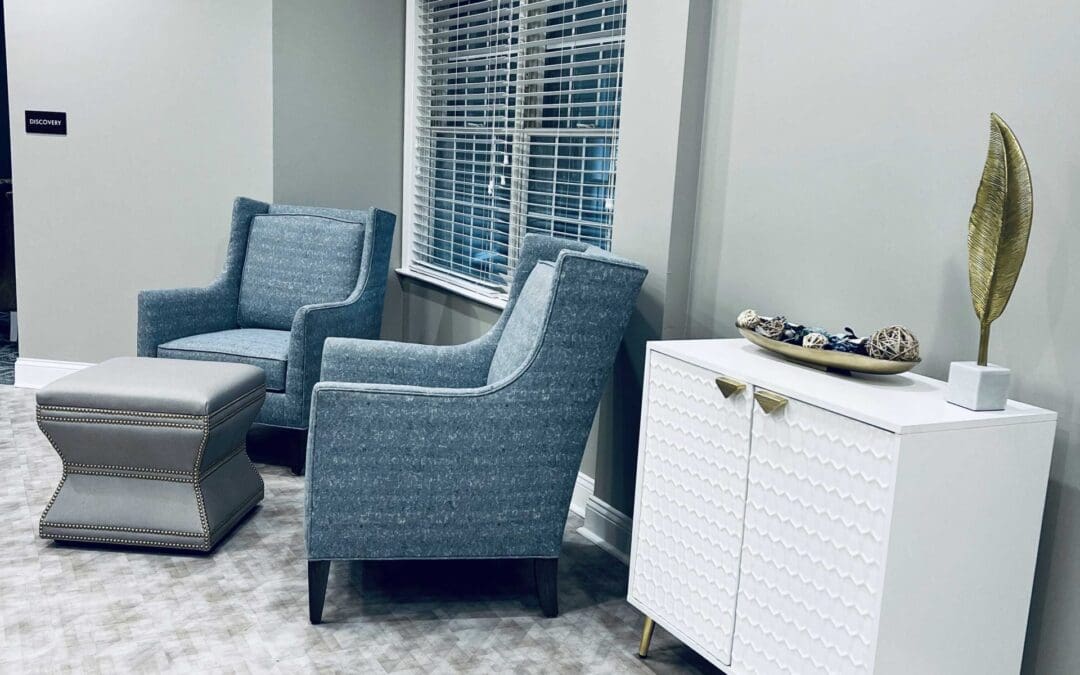 seating area with arm chairs and window