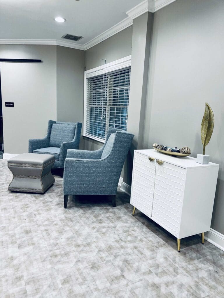 seating area with arm chairs and window